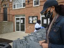 Photo of a person filling bags Photo of a person filling bags